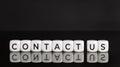 Contact us phrase on white blocks shape on black background