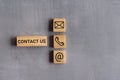 Contact us text and icon on wooden cubes. Copy space for text Royalty Free Stock Photo