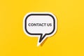 Contact Us text on speech bubble isolated on yellow