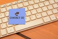 Contact us wrriten on notepad with computer keyboard in background Royalty Free Stock Photo