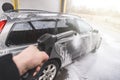 Contactless  car wash self service system. Washing dirty car in car wash station with foam Royalty Free Stock Photo