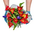 Contactless flower delivery, male courier in medical gloves with a bouquet of red tulips and irises Royalty Free Stock Photo