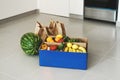 Local fruits and vegetables in a paper box and bags