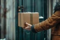 Contactless home delivery service. hands holding package near front door for safe drop-off