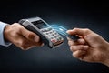 Contactless payment transaction with credit card and wireless terminal in hands Royalty Free Stock Photo