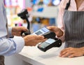 Contactless Payment Transaction Using Mobile Device at Retail Counter Royalty Free Stock Photo