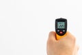 Contactless thermometer measuring with white background and copyspace area. Check temperature and control tools and equipment for Royalty Free Stock Photo