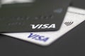 Contactless Visa payment cards closeup. Two black and white Visa credit cards close up. Selective focus