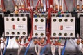 Contactors with front contacts are arranged in a row in the electrical Cabinet