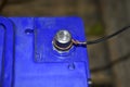 Contacts of a blue car battery charging in the garage Royalty Free Stock Photo