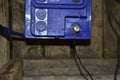 Contacts of a blue car battery charging in the garage Royalty Free Stock Photo