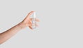 Contagious disease protection. Female hand holding bottle of sanitizer on white background, copy space