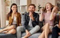 Contagious laughter. Group of cheerful young multicultural friends in casual wear enjoying time together while sitting Royalty Free Stock Photo