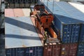 Container attached to spreader of gantry cranes operated by stevedores are loaded on the ship. Royalty Free Stock Photo