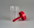 Container for biomaterial with spoon