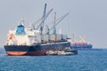 Container boat loading goods over clear blue water sea use for v