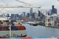 Container cargo freight ship in the container terminal with gantry cranes situated in port of Seattle, Washington, USA.