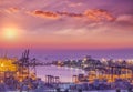 Container Cargo freight ship with working crane bridge in shipyard at dusk Royalty Free Stock Photo