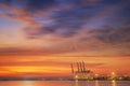 Container Cargo freight ship with working crane bridge in shipyard at dusk Royalty Free Stock Photo