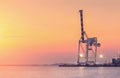 Container Cargo freight ship with working crane bridge in shipyard at dusk for Logistic Import Export Royalty Free Stock Photo