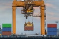 Container Cargo freight ship with working crane loading bridge i Royalty Free Stock Photo