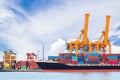 Container cargo freight ship with working crane loading bridge Royalty Free Stock Photo