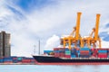 Container cargo freight ship with working crane loading bridge Royalty Free Stock Photo