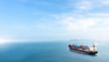 Container cargo ship in the ocean at sunset blue sky background with copy space, Nautical vessel and sea freight shipping Royalty Free Stock Photo