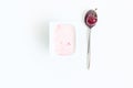 Container with cherry yogurt and spoon with one cherry berry, to