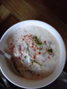 A Container containing onion raita, an Indian dish close up view.