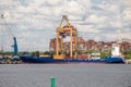Container crane unloads container ship in Moby Dik terminal, Kronshtadt, Russia Royalty Free Stock Photo