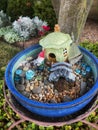 Container fairy garden enhances the landscape. Royalty Free Stock Photo