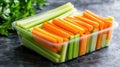 A container filled with fresh celery and carrot sticks, perfect for snacking Royalty Free Stock Photo