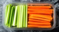 A container filled with fresh celery and carrot sticks, perfect for snacking Royalty Free Stock Photo