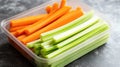 A container filled with fresh celery and carrot sticks, perfect for snacking Royalty Free Stock Photo