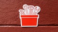 Container Filled With Various Tools in a Red Bucket Against a Textured Wall Background, Showcasing a Combination of Royalty Free Stock Photo