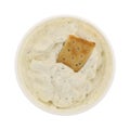Container of French onion dip with cracker Royalty Free Stock Photo