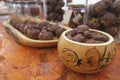 Container hand painted pumpkin, containing dried cocoa beans.