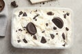 Container of ice cream and chocolate cookies on grey, top view Royalty Free Stock Photo