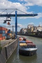 Container loading with a blue container handling portal crane in the osthafen