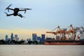 Modern RC Drone / Quadcopter with camera flying on container cargo ship at shipping port. double exposure Royalty Free Stock Photo