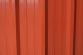 Container metal orange wall texture background. Color panel red-orange color building facade. Royalty Free Stock Photo