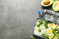 Container with natural healthy lunch, bottle of water and space for text on table, top view. Royalty Free Stock Photo