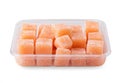 A container of orange-colored fruit jelly cubes dusted with sugar Royalty Free Stock Photo