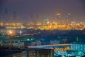 Container port with cityscape at night