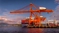 Container Port with the Large Container Cranes loading a Ocean Going Freighter in Vancouver Harbor