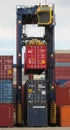 Container reach stacker moving shipping containers around the storage yard at Southampton docks UK