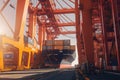 Container ship at the berth in cargo terminal of the port under loading. Port cranes load containers, place them on the Royalty Free Stock Photo