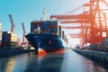 Container ship at the berth in cargo terminal of the port under loading. Port cranes load containers, place them in rows