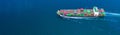 Container ship carrying container for import and export, business logistic and transportation by ship in open sea, Aerial view Royalty Free Stock Photo